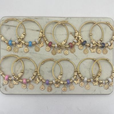 BLISTER DE PULSERAS ACERO DORADO PANDORA REGULABLE - MARIPOSA Y FLORES CON DONAS Y BOLA DE FUEGO - Imagen 1