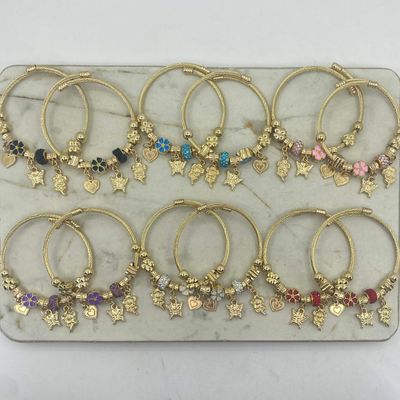 BLISTER DE PULSERAS ACERO DORADO PANDORA REGULABLE - BOLA DE FUEGO Y FLOR ESMALTADA - Imagen 1